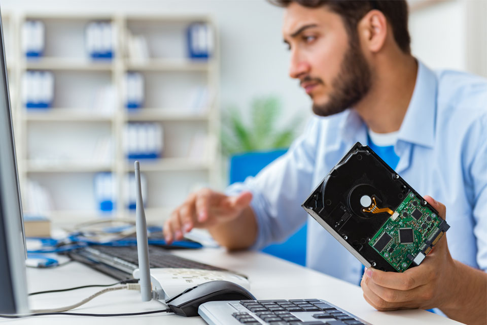 Technician with broken hard drive