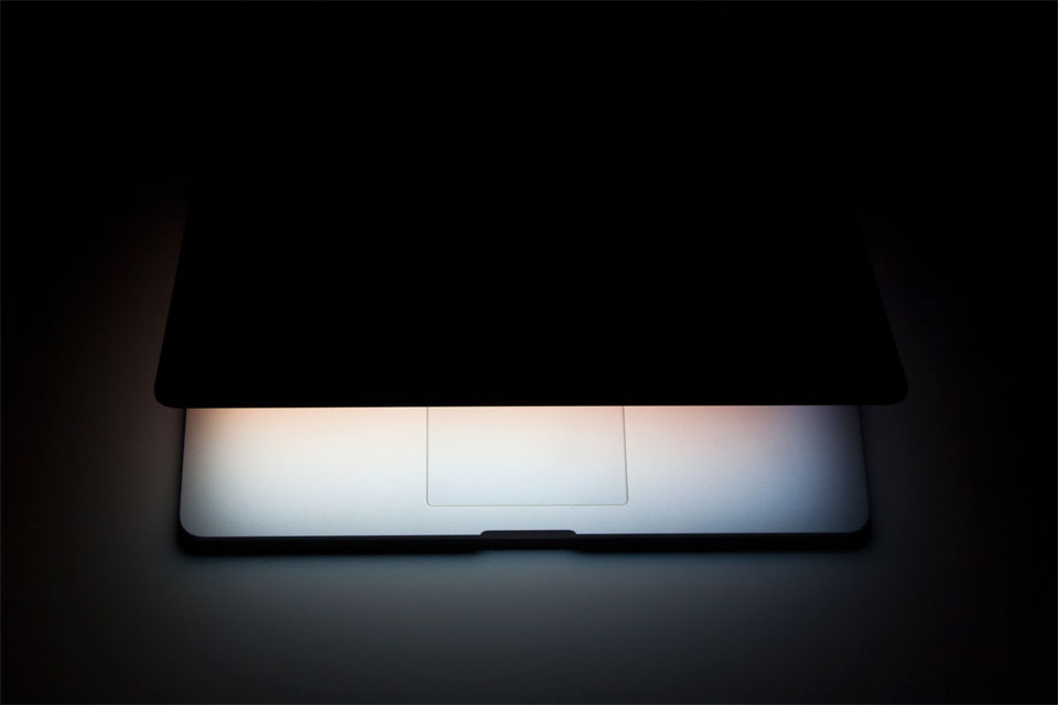 Half closed silver aluminium laptop