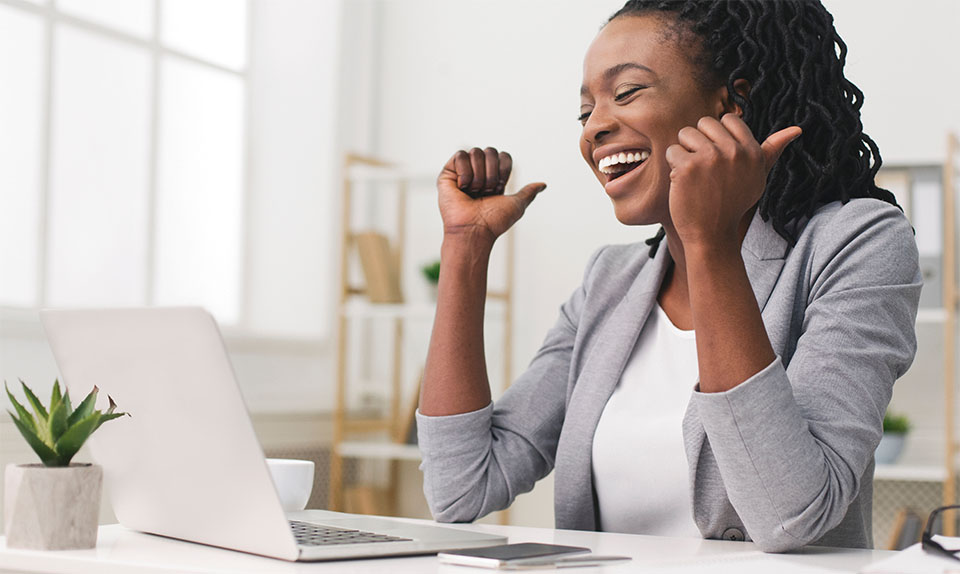 Happy African American Woman in Front of Laptop