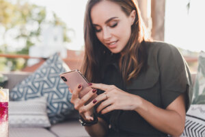 Young Beauty Girl Using Device