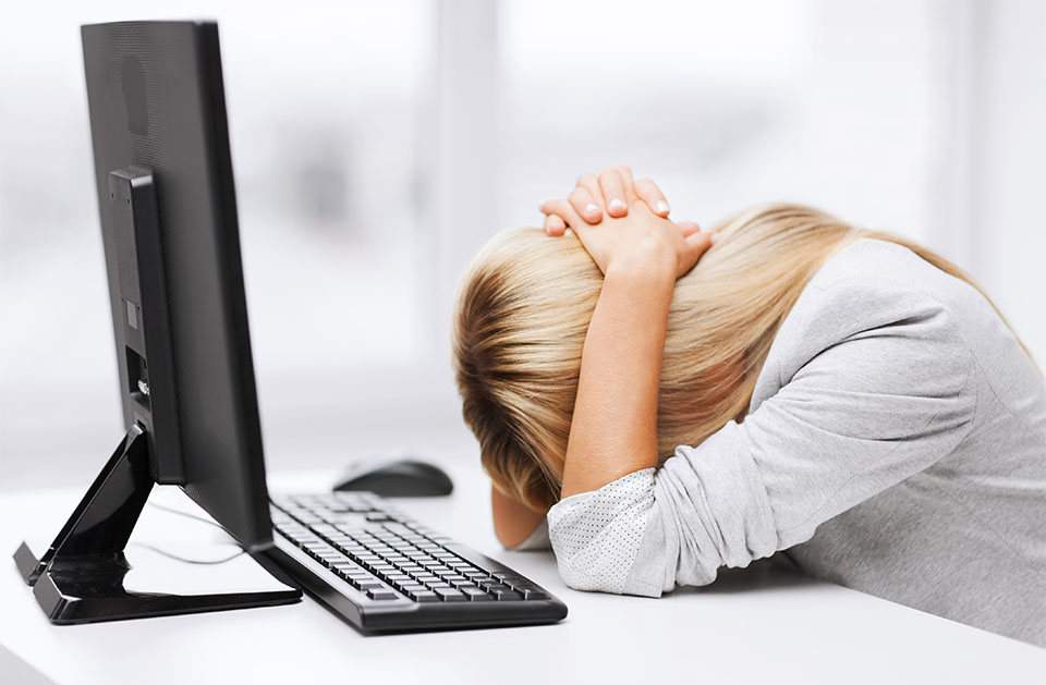 Exhausted Woman in Front of Computer